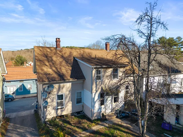 a view of a house with a yard and garage