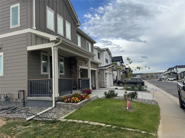 a view of a chair and table in backyard of the house