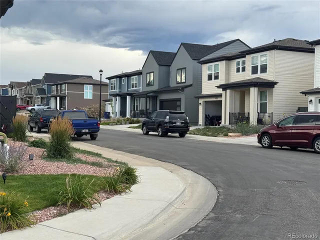 a car parked in front of a brick house