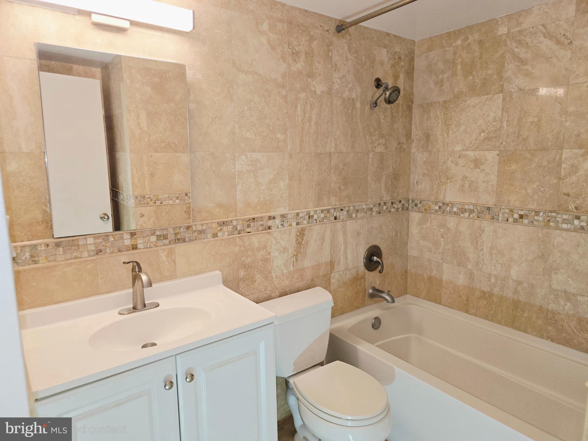 1425 4th Street Southwest, Unit A609 Washington, DC 20024 - Photo 9 of 12 a bathroom with a sink a toilet and shower