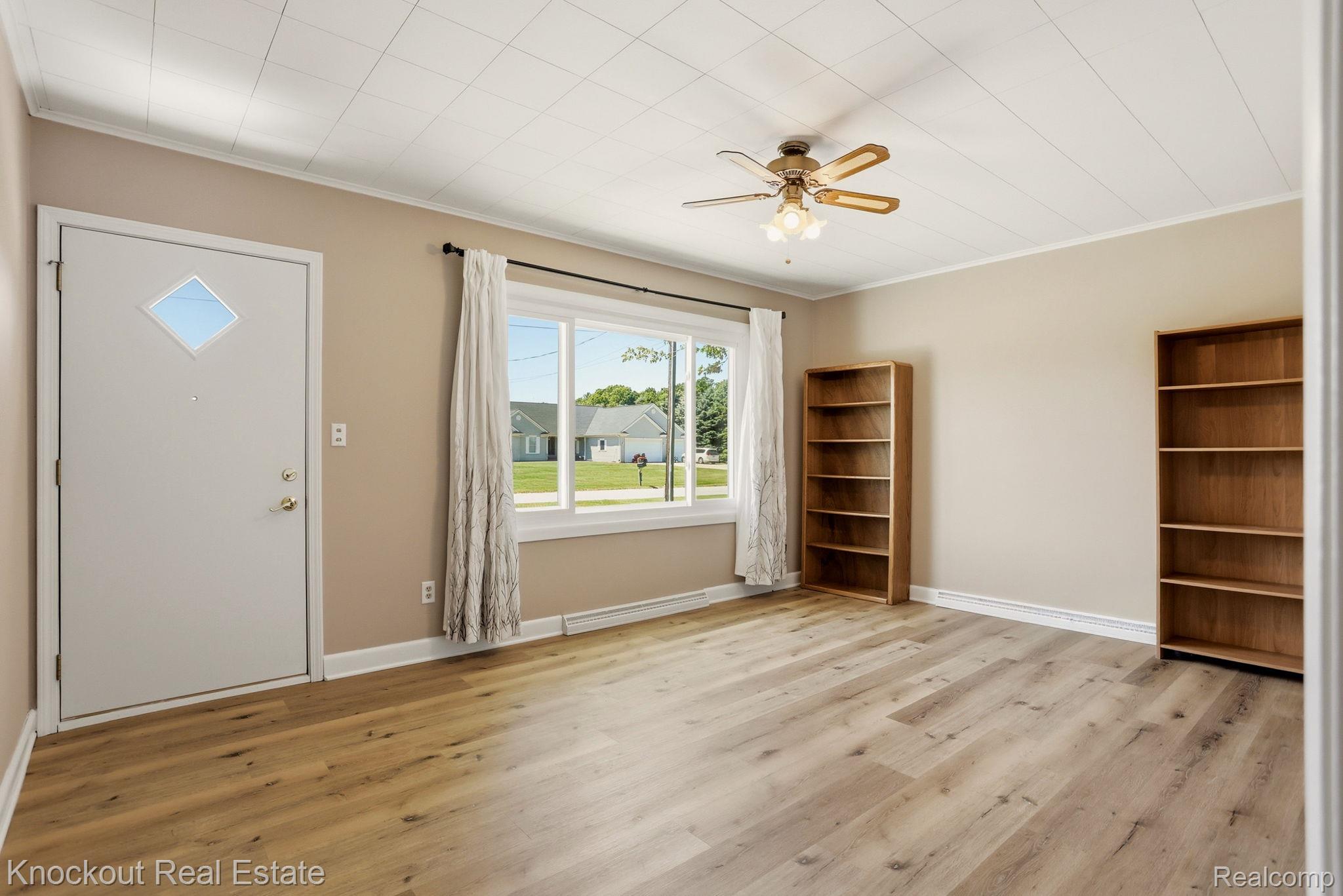 9941 Lange Road Birch Run, MI 48415 - Photo 20 of 42 Spacious room featuring light wood-finish flooring, neutral wall tones, and a white ceiling with a textured finish