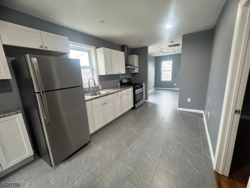 17 Home Street Somerset, NJ 08873 - Photo 14 of 20 a kitchen with stainless steel appliances a refrigerator a sink a stove a microwave a counter top and cabinets
