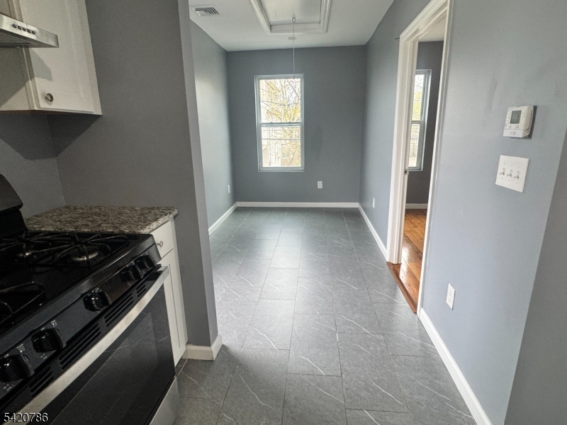 17 Home Street Somerset, NJ 08873 - Photo 16 of 20 a kitchen with granite countertop a stove and a refrigerator