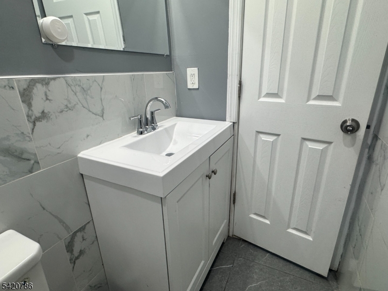 17 Home Street Somerset, NJ 08873 - Photo 20 of 20 a bathroom with a sink a toilet and mirror