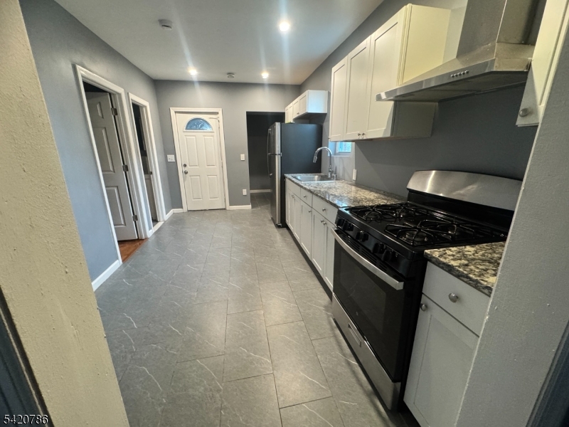 17 Home Street Somerset, NJ 08873 - Photo 7 of 20 a kitchen with stainless steel appliances granite countertop a stove a refrigerator and a sink