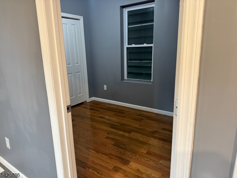 17 Home Street Somerset, NJ 08873 - Photo 10 of 20 a view of an empty room with wooden floor and a window