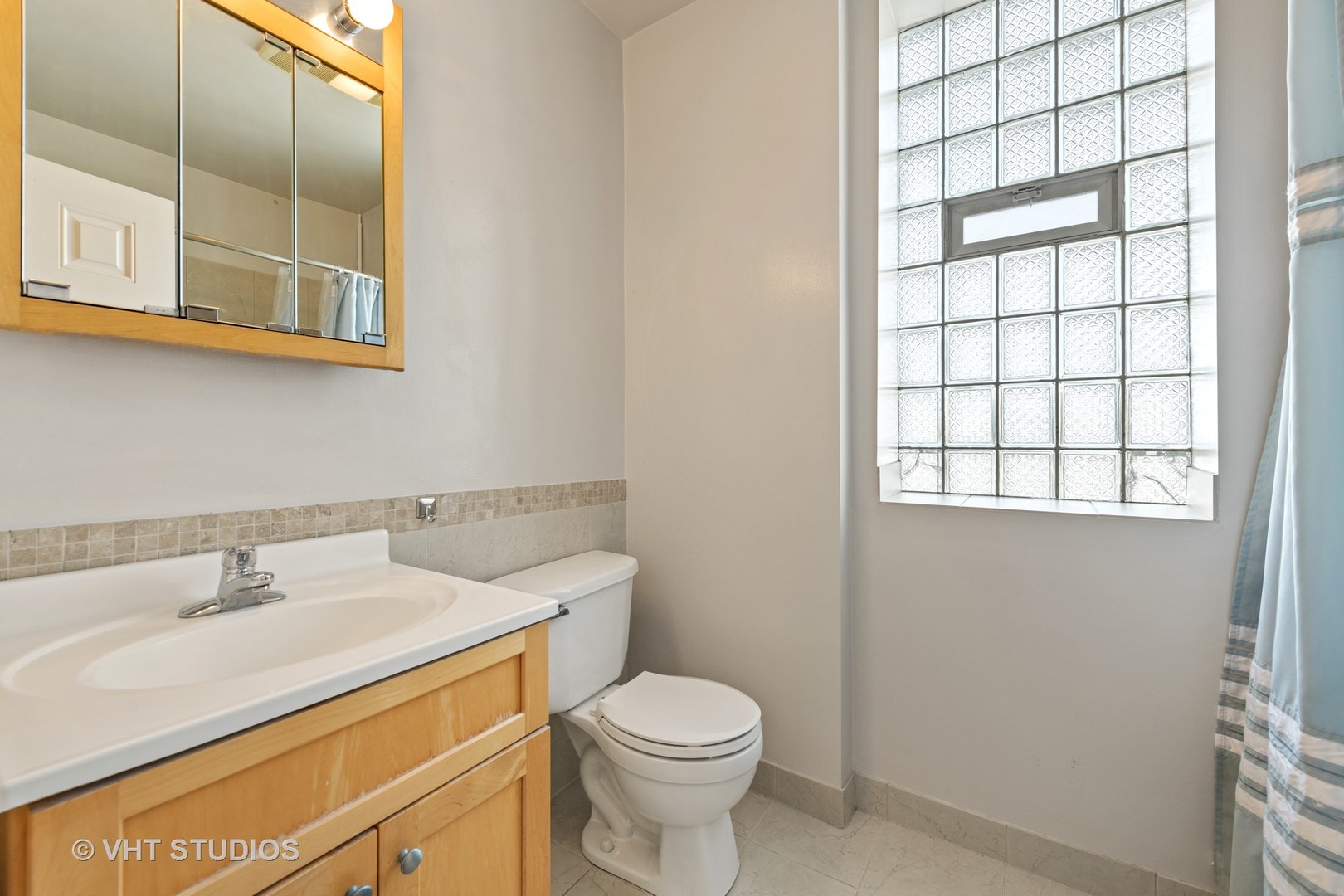 1530 West Edgewater Avenue, Unit 2R Chicago, IL 60660 - Photo 11 of 12 a bathroom with a sink a toilet and a window