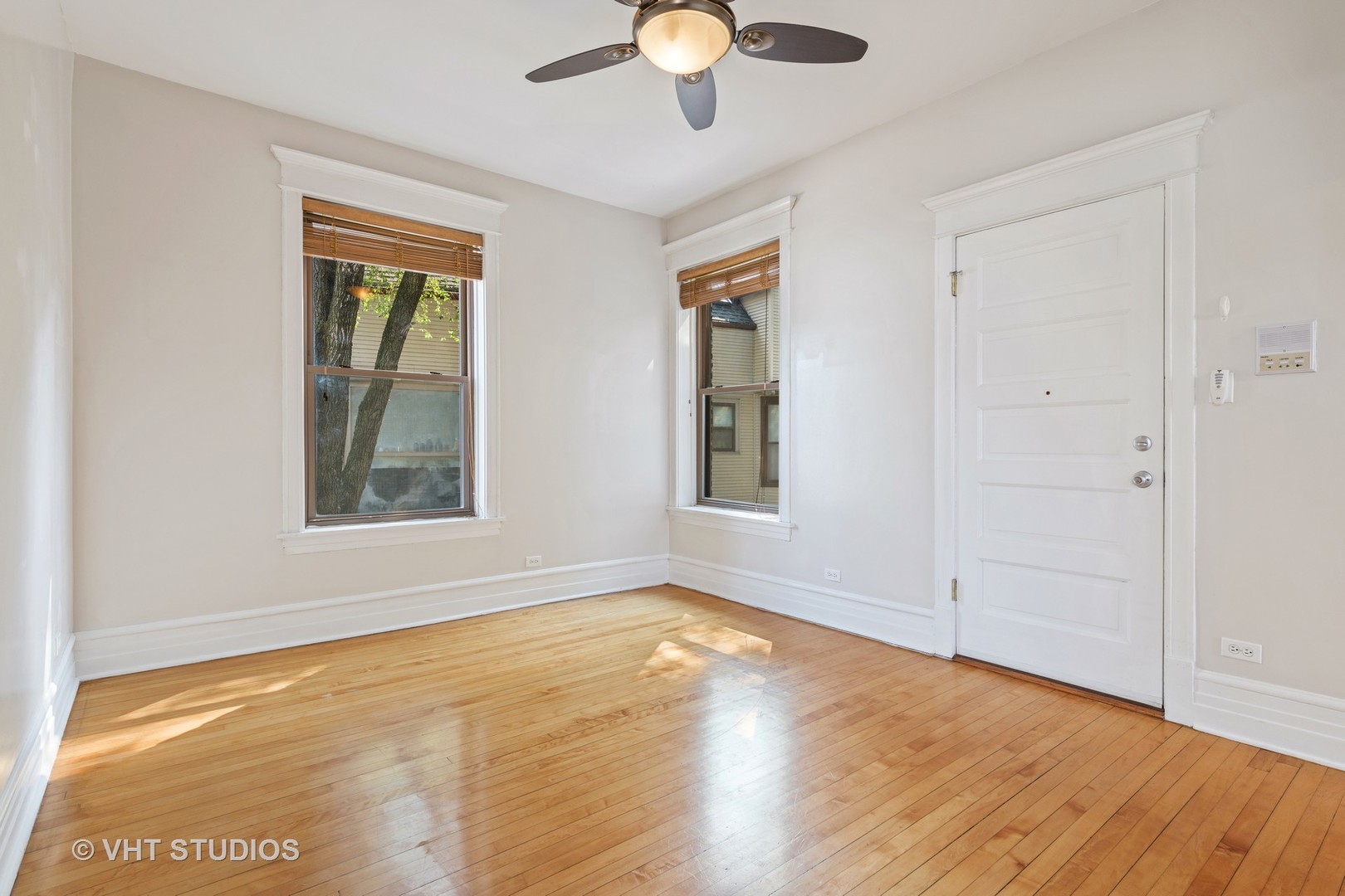 1530 West Edgewater Avenue, Unit 2R Chicago, IL 60660 - Photo 4 of 12 a view of an empty room with wooden floor and a window
