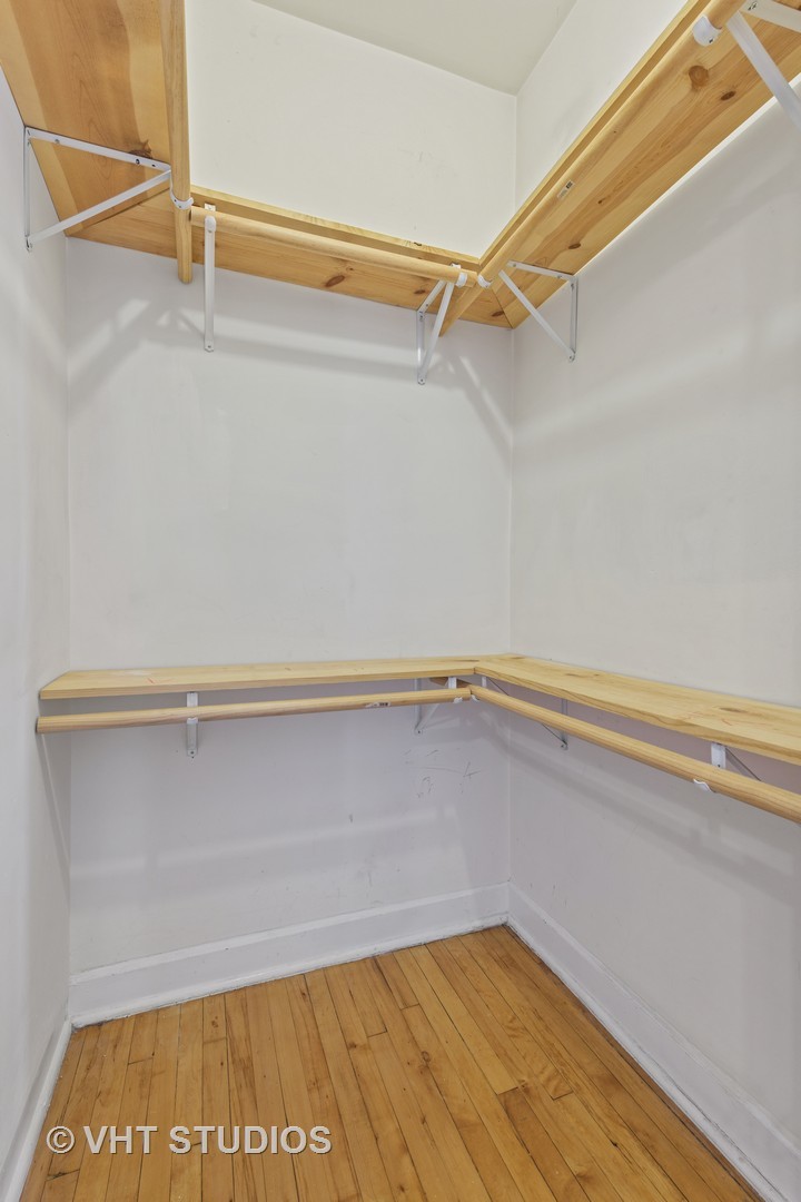 1530 West Edgewater Avenue, Unit 2R Chicago, IL 60660 - Photo 7 of 12 a view of a room with racks on the wall