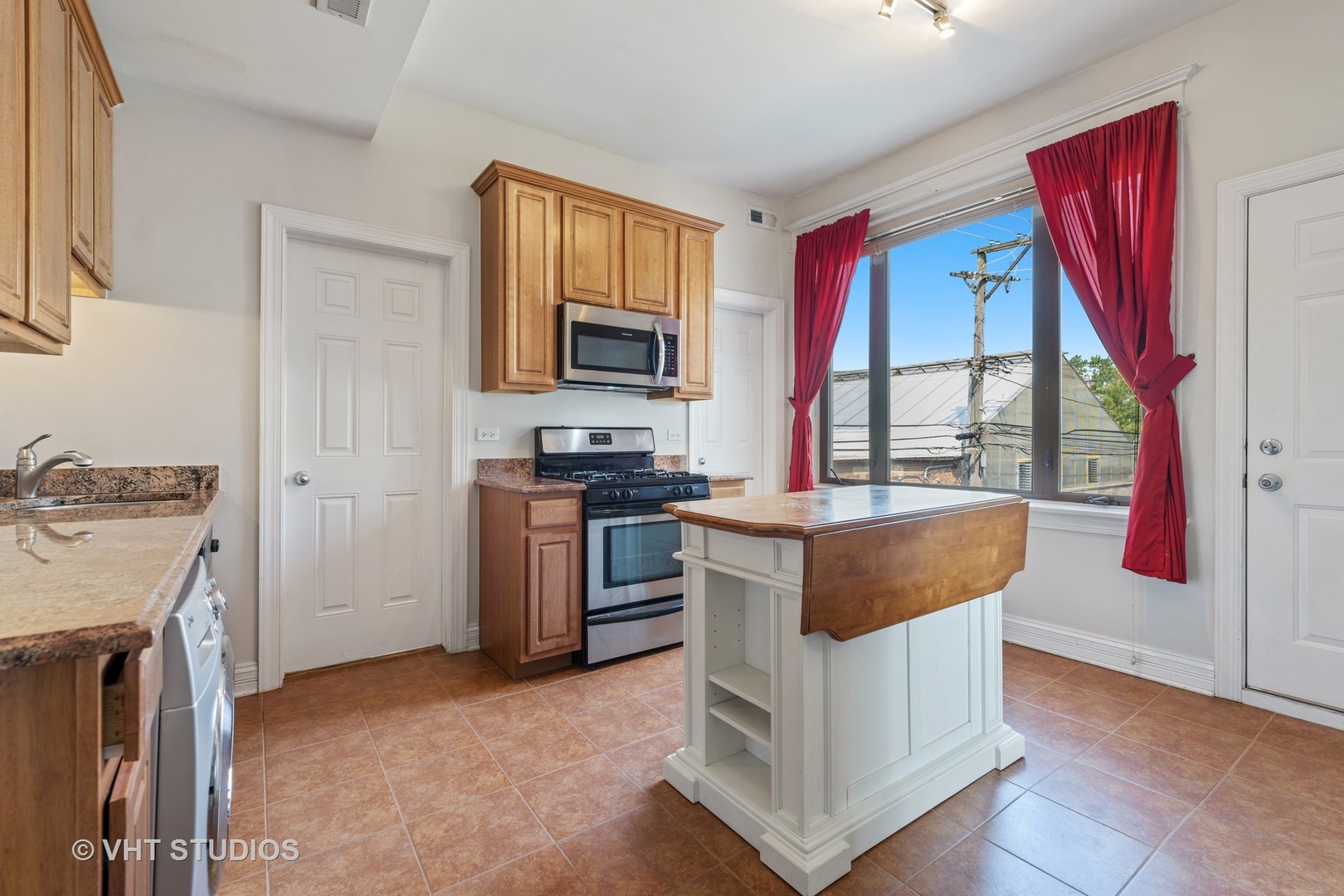 1530 West Edgewater Avenue, Unit 2R Chicago, IL 60660 - Photo 8 of 12 a kitchen with stainless steel appliances granite countertop a stove a refrigerator and a stove