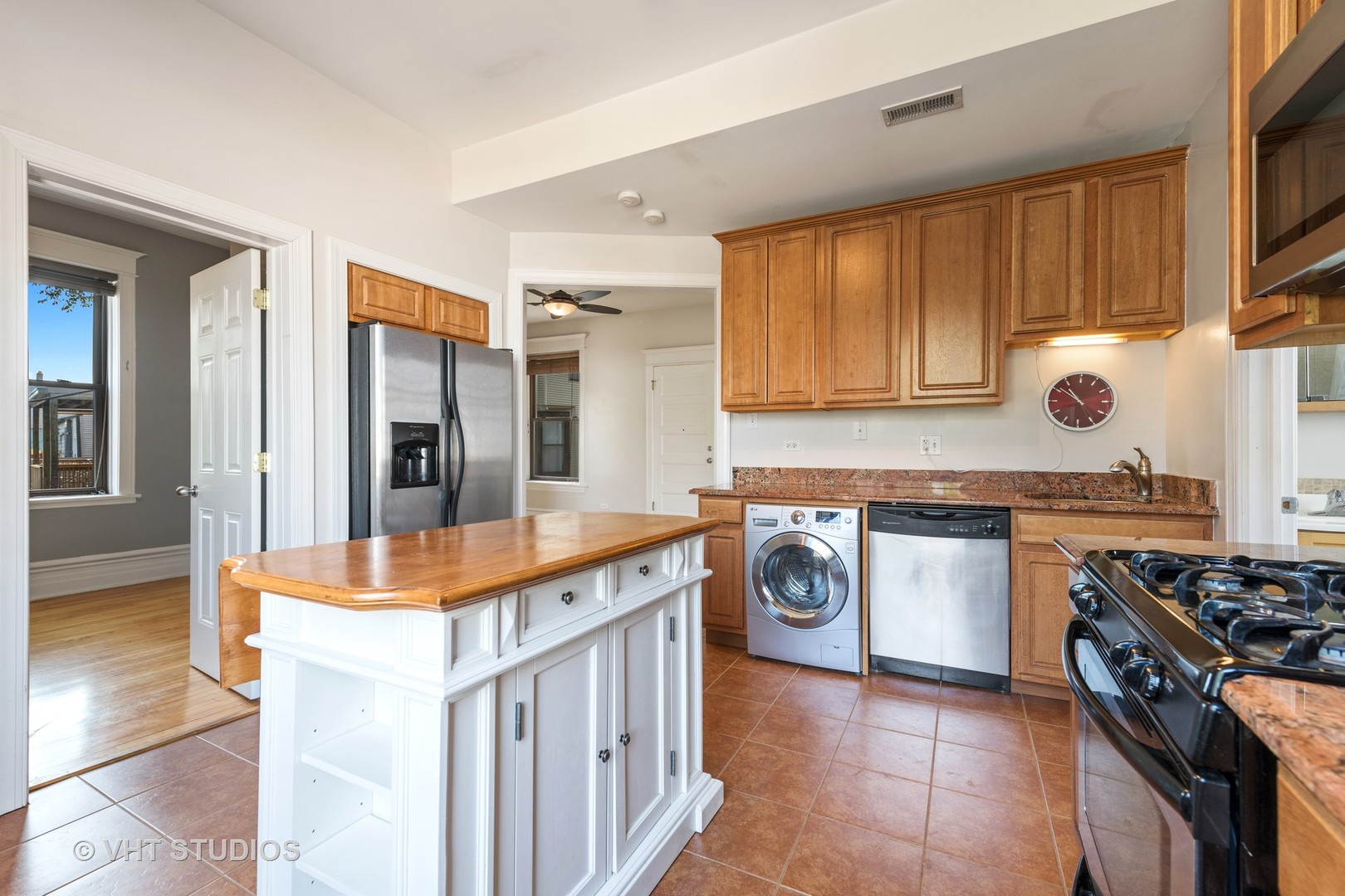 1530 West Edgewater Avenue, Unit 2R Chicago, IL 60660 - Photo 9 of 12 a kitchen with stainless steel appliances granite countertop a stove a sink and a refrigerator