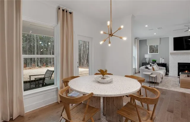 a view of a dining room with furniture and a window