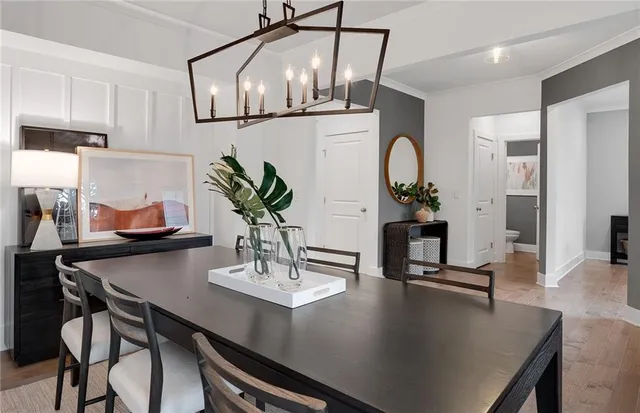 a dining room with kitchen island a table and chairs in it