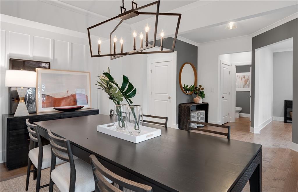 239 Rockledge Bend Southwest Powder Springs, GA 30127 - Photo 16 of 16 a dining room with kitchen island a table and chairs in it
