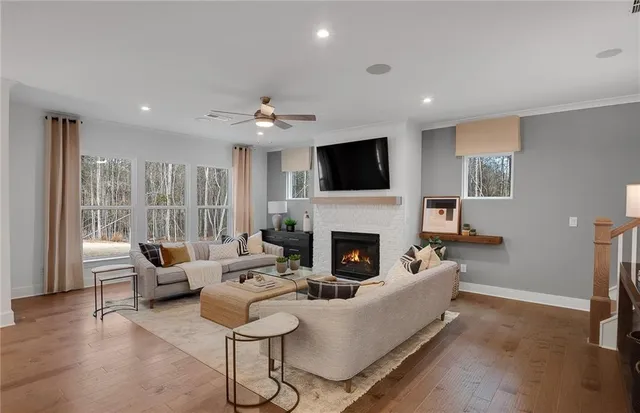 a living room with furniture a fireplace and a flat screen tv