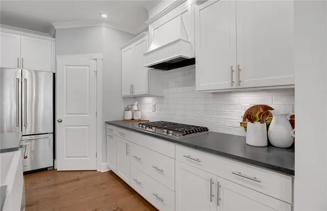 a kitchen with cabinets and a stove top oven