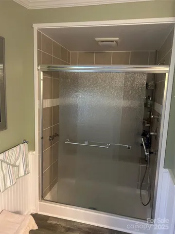 a bathroom with a glass shower door