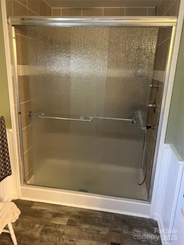 a bedroom with a bed and a television