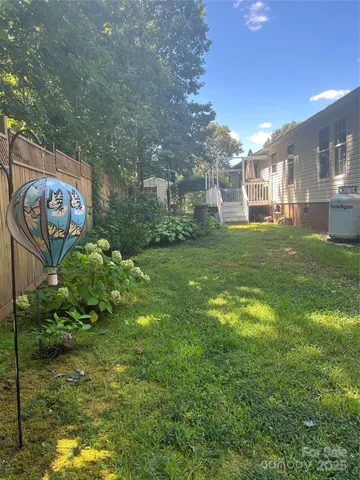 a view of yard with swimming pool and seating space