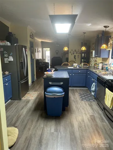 a stove top oven sitting inside of a kitchen and granite counter tops