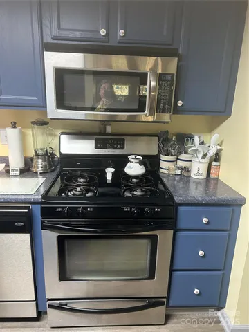 a kitchen with a sink cabinets and a window