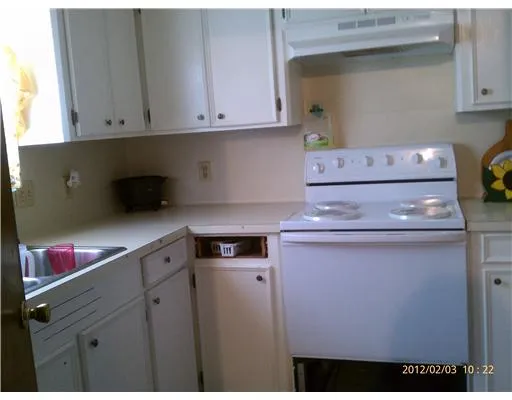 a kitchen with a stove and cabinets