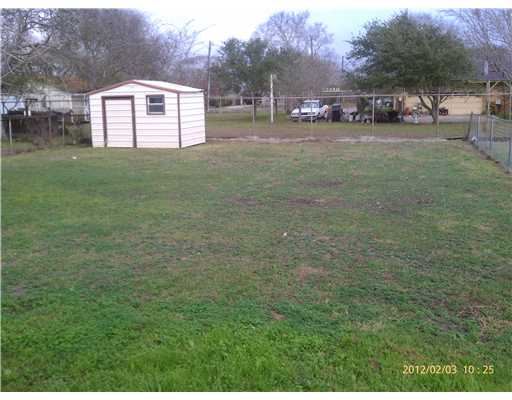 123 Dell Street Portland, TX 78374 - Photo 9 of 10 a view of a back yard of the house with a street