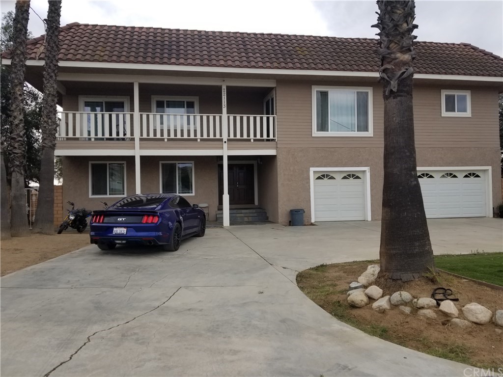 22113 Cajalco Road Perris, CA 92570 - Photo 1 of 1 a car parked in front of a house