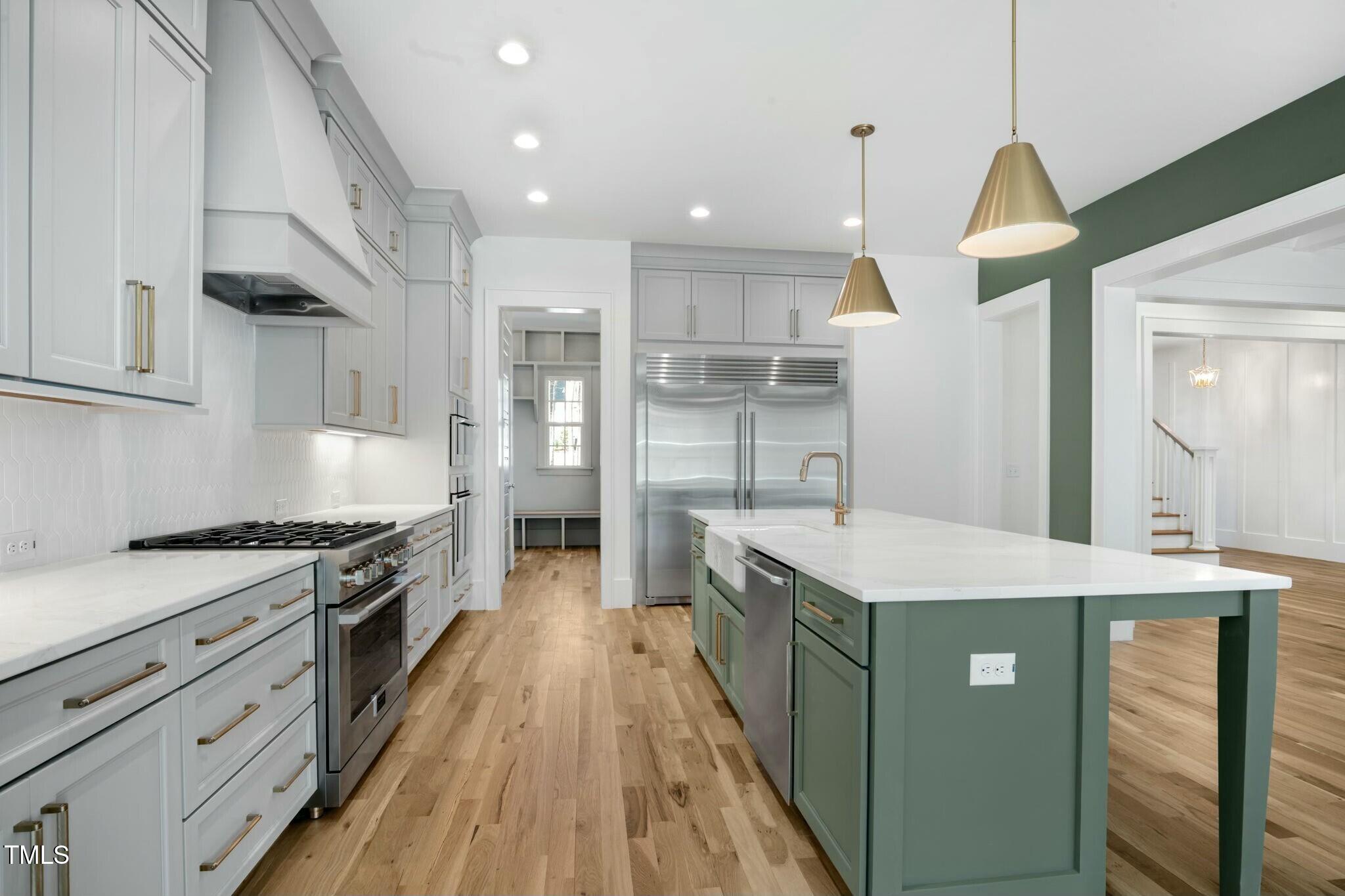 7112 Camp Side Court Raleigh, NC 27613 - Photo 15 of 39 a kitchen with stainless steel appliances granite countertop a sink stove and refrigerator