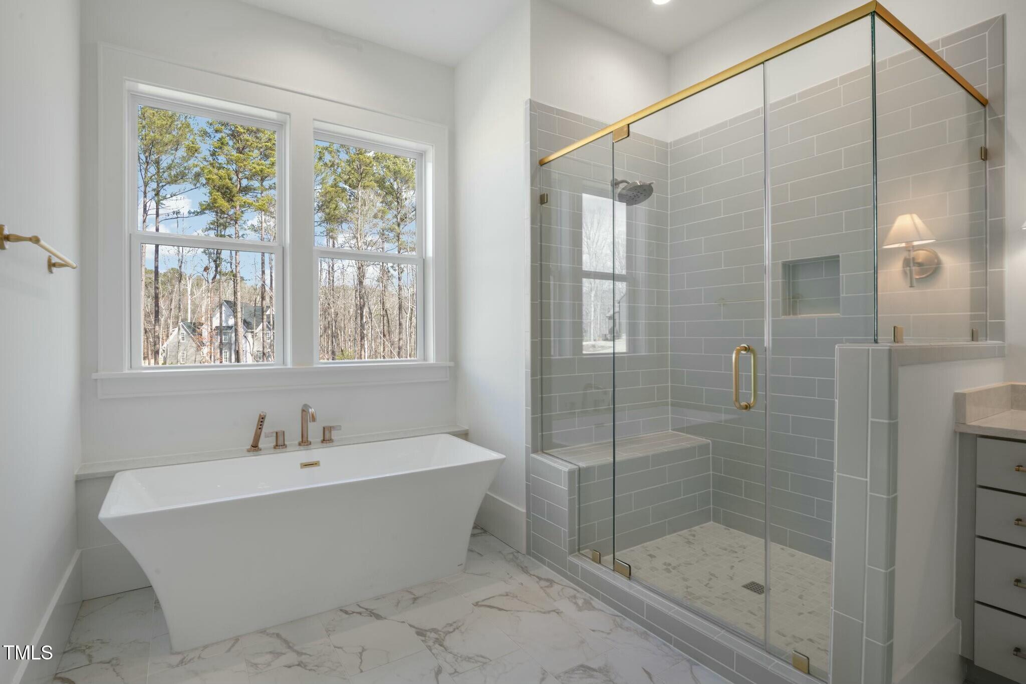 7112 Camp Side Court Raleigh, NC 27613 - Photo 17 of 39 a bathroom with a bathtub and shower