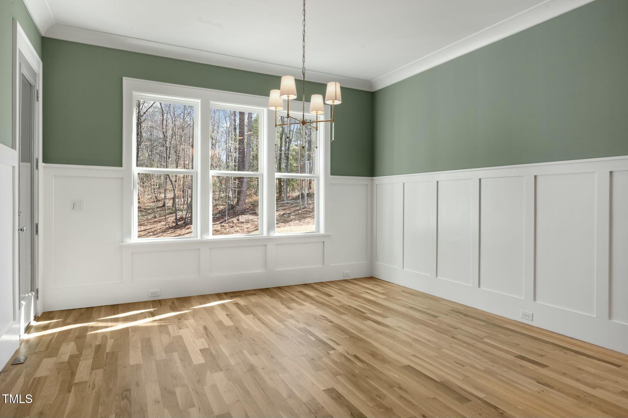 7112 Camp Side Court Raleigh, NC 27613 - Photo 18 of 39 a view of an empty room with wooden floor and a window