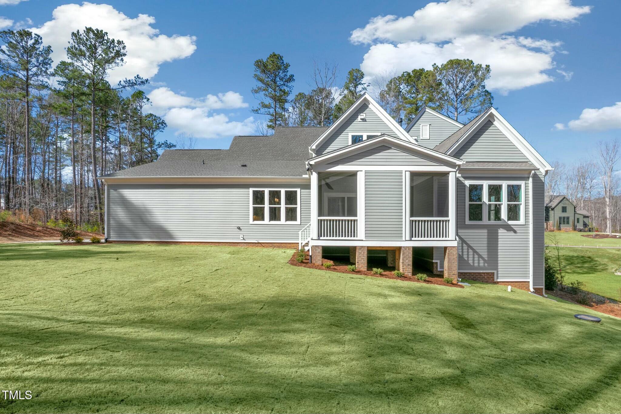 7112 Camp Side Court Raleigh, NC 27613 - Photo 2 of 39 a front view of a house with a garden