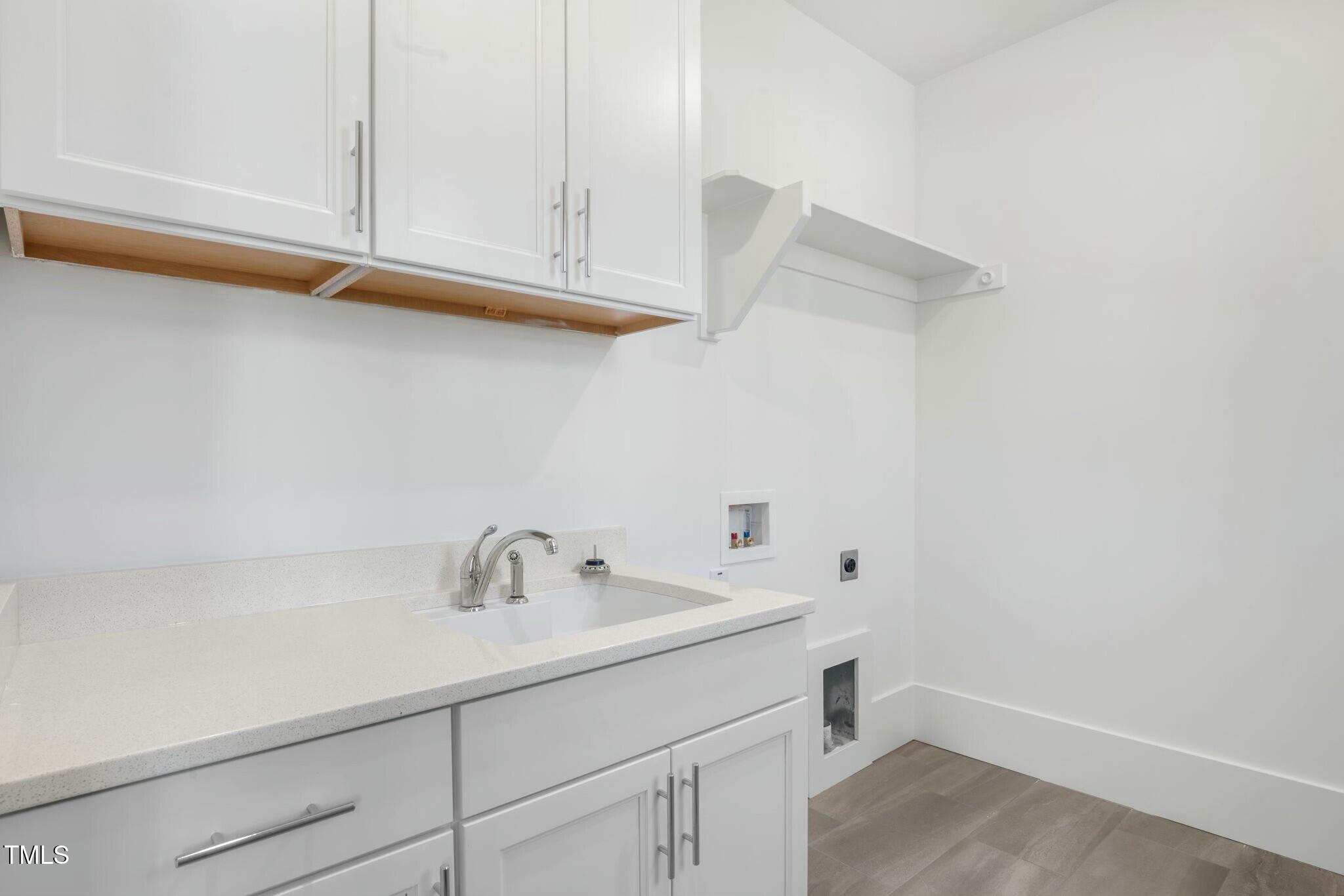 7112 Camp Side Court Raleigh, NC 27613 - Photo 21 of 39 a bathroom with a sink and cabinets