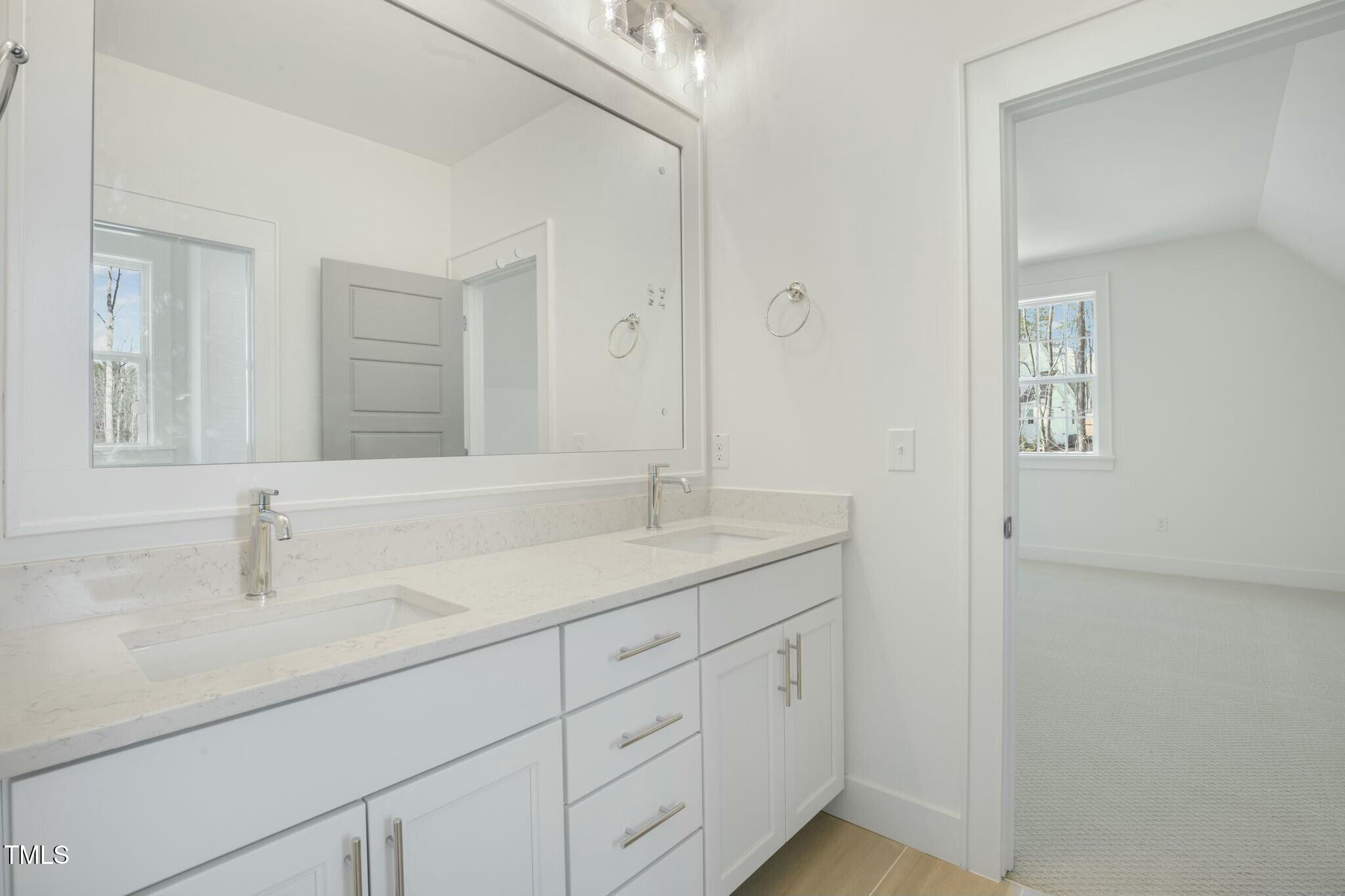 7112 Camp Side Court Raleigh, NC 27613 - Photo 23 of 39 a bathroom with a sink and a mirror