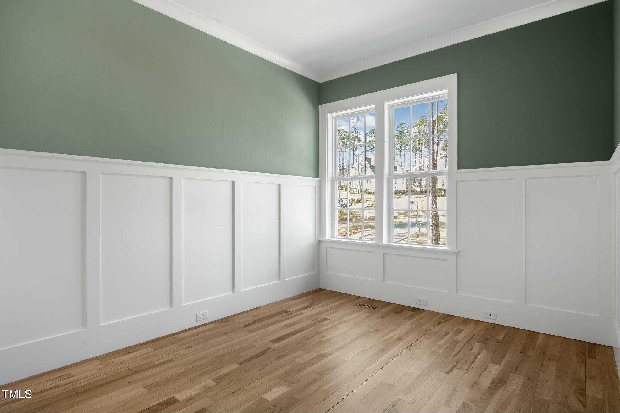 7112 Camp Side Court Raleigh, NC 27613 - Photo 25 of 39 an empty room with wooden floor and windows