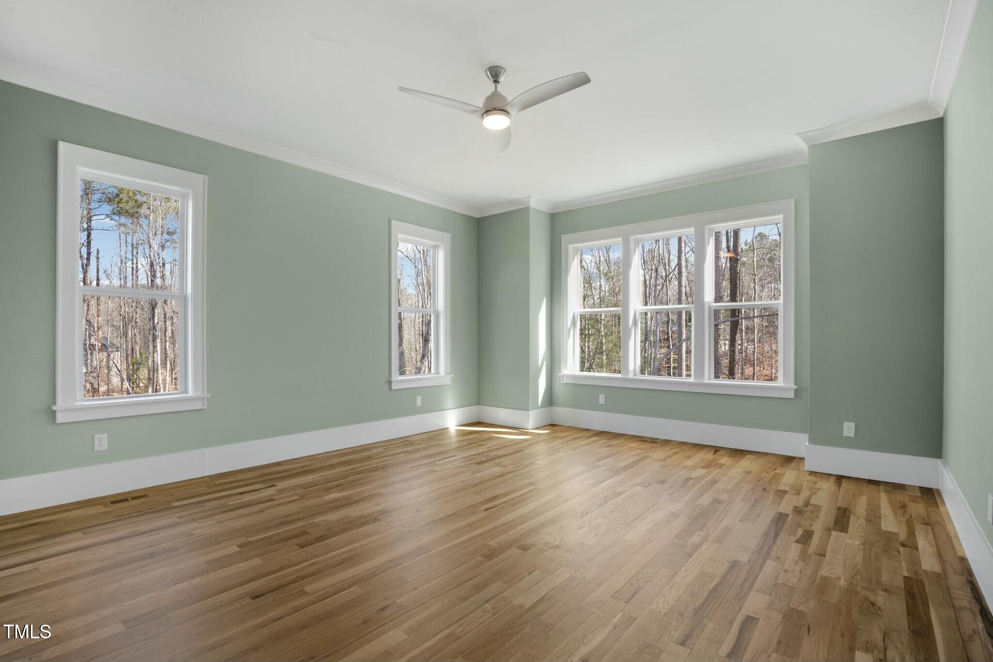 7112 Camp Side Court Raleigh, NC 27613 - Photo 27 of 39 a view of an empty room with wooden floor and a window