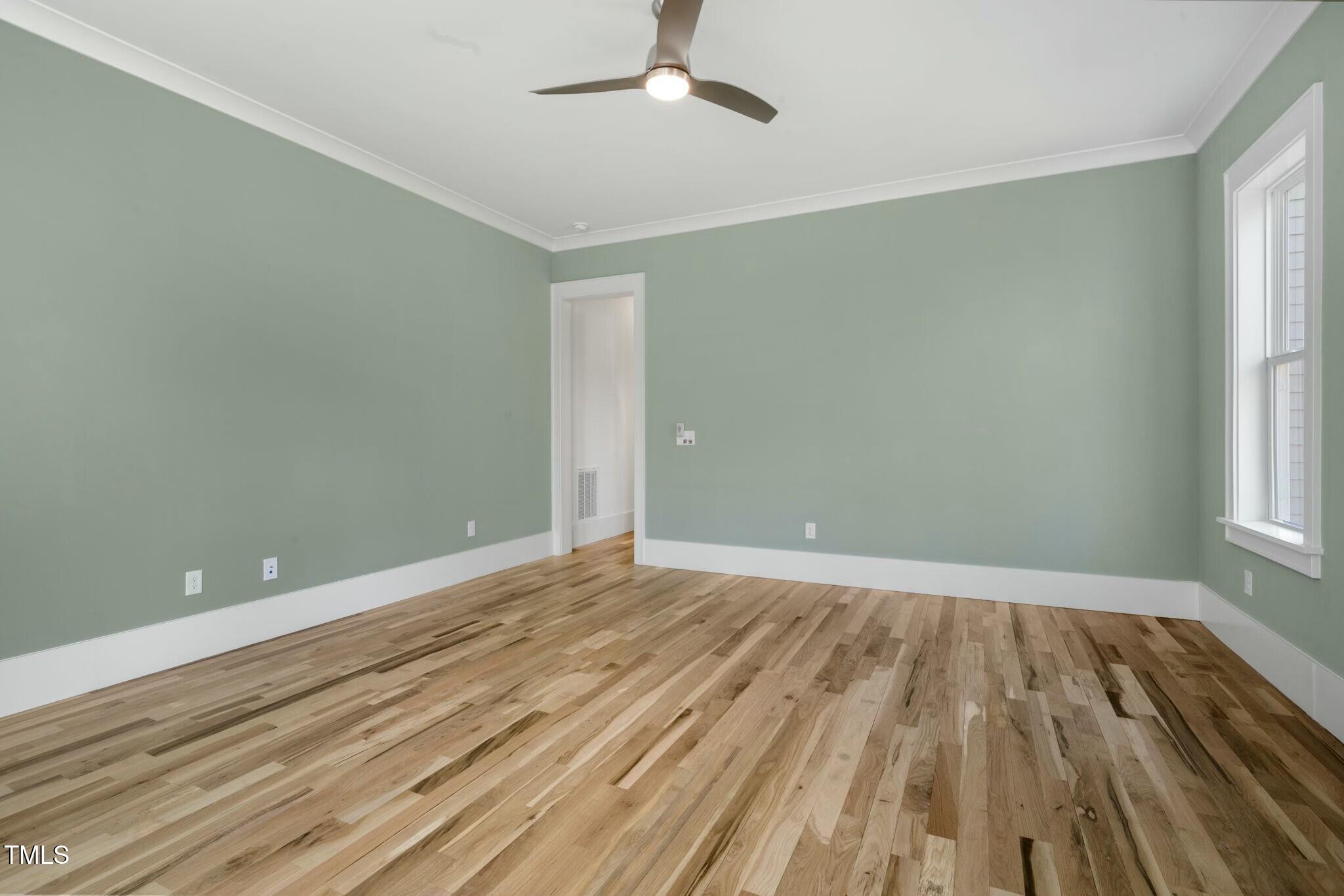 7112 Camp Side Court Raleigh, NC 27613 - Photo 29 of 39 wooden floor in an empty room with a window