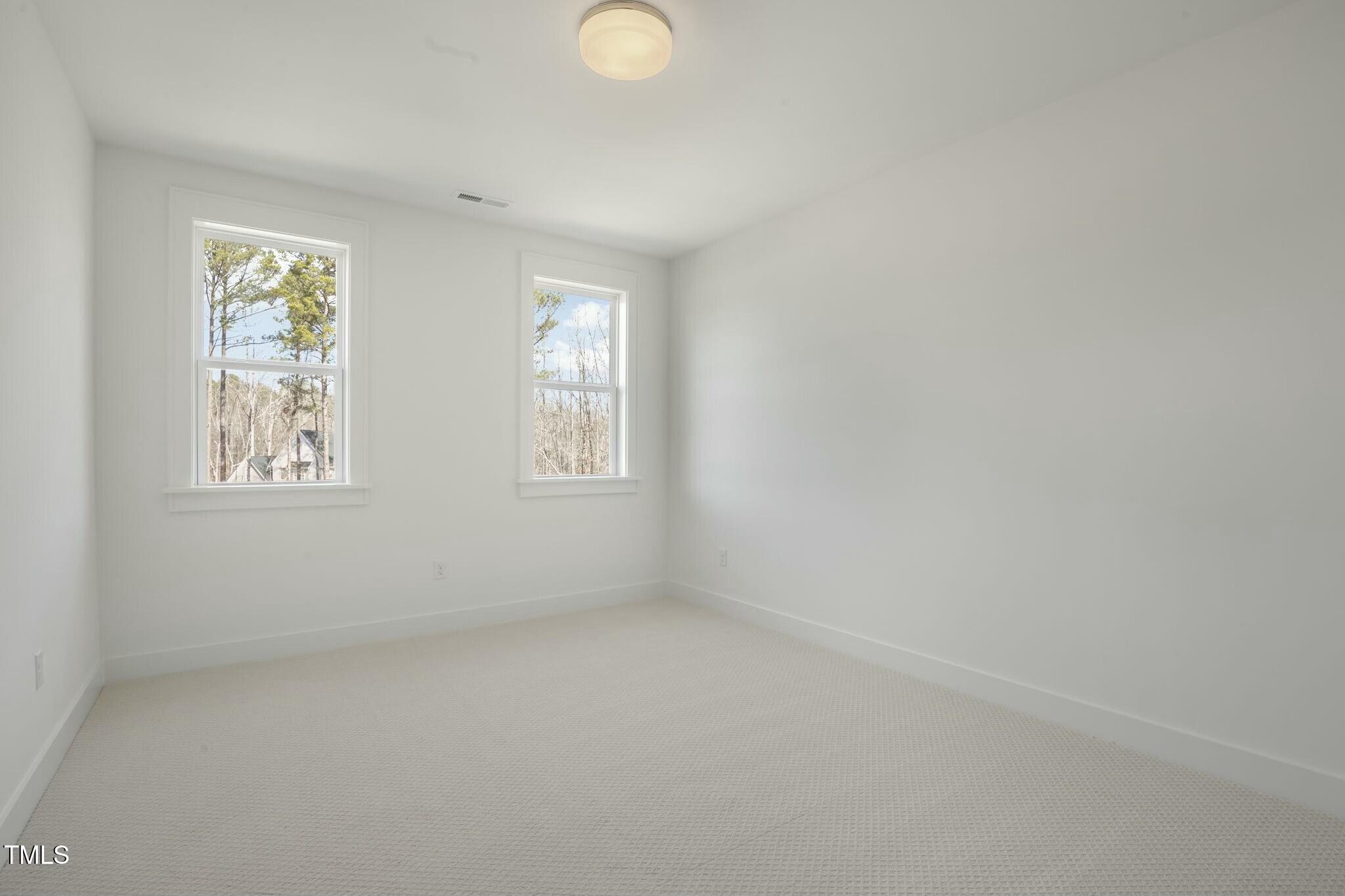 7112 Camp Side Court Raleigh, NC 27613 - Photo 35 of 39 an empty room with windows
