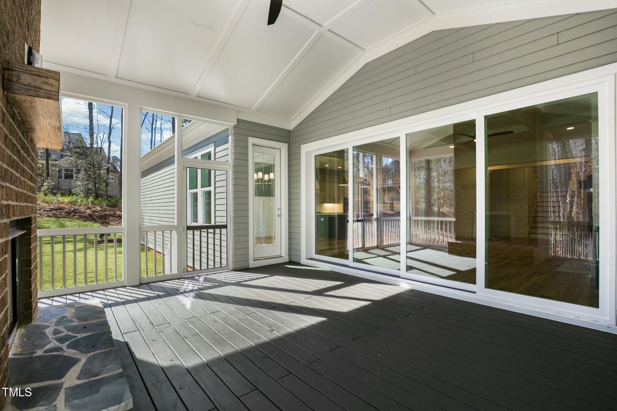 7112 Camp Side Court Raleigh, NC 27613 - Photo 5 of 39 a porch with a table and chairs
