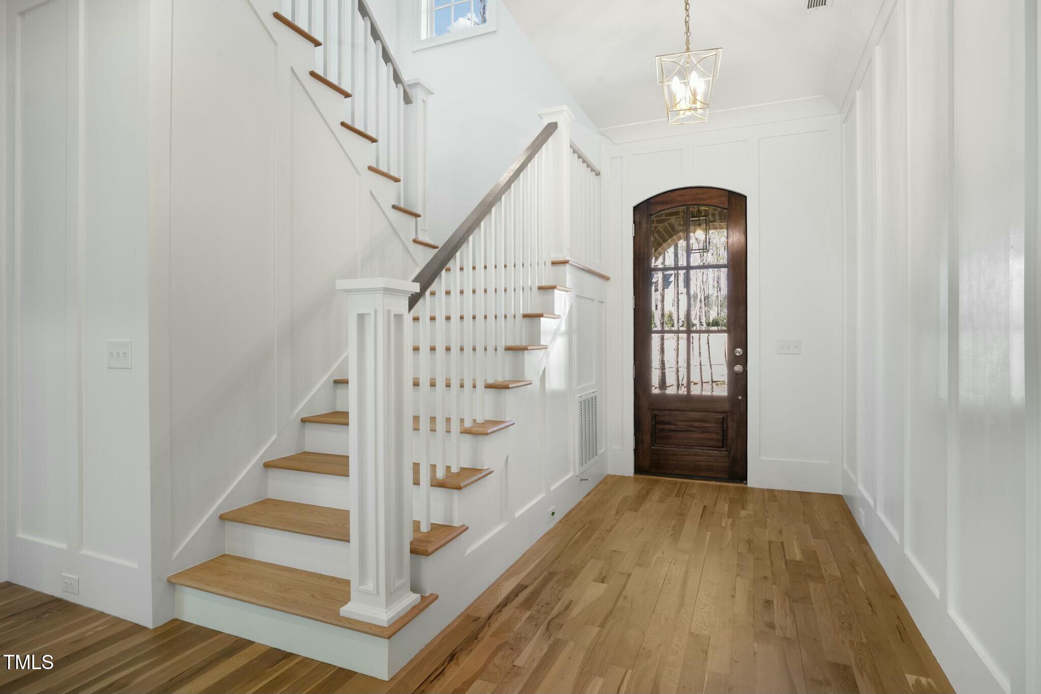 7112 Camp Side Court Raleigh, NC 27613 - Photo 7 of 39 a view of entryway with wooden floor and stairs