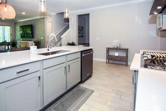 a kitchen with stainless steel appliances granite countertop a stove a refrigerator and a sink