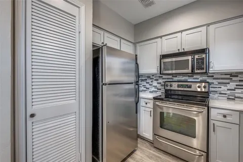 a kitchen with a stove microwave and refrigerator