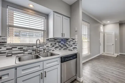 a kitchen with a sink and cabinets