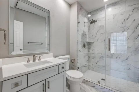 a bathroom with a sink toilet and shower