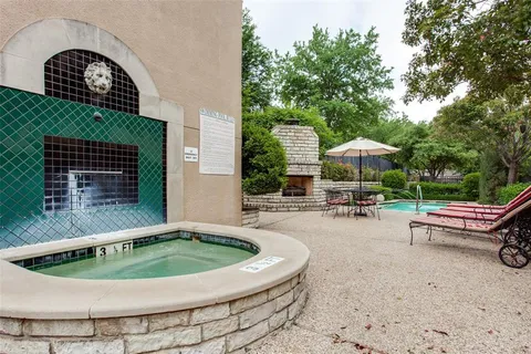 a view of a swimming pool with a patio and a garden
