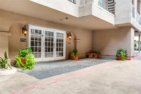a view of a house with potted plants in front of door