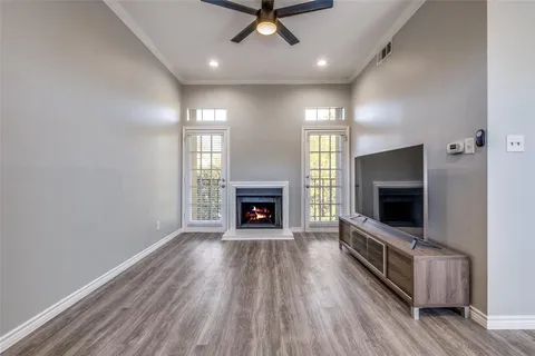 a view of a livingroom with a fireplace a window and a fireplace