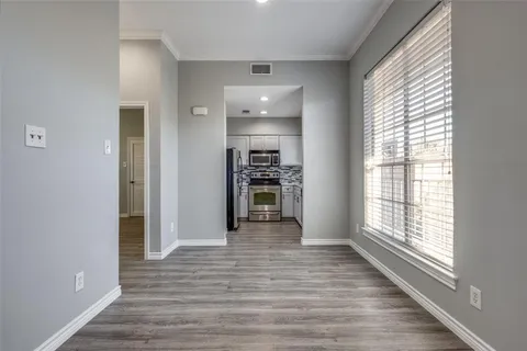 wooden floor in an empty room with a window and wooden floor