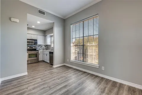 a view of kitchen with granite countertop cabinets and wooden floor