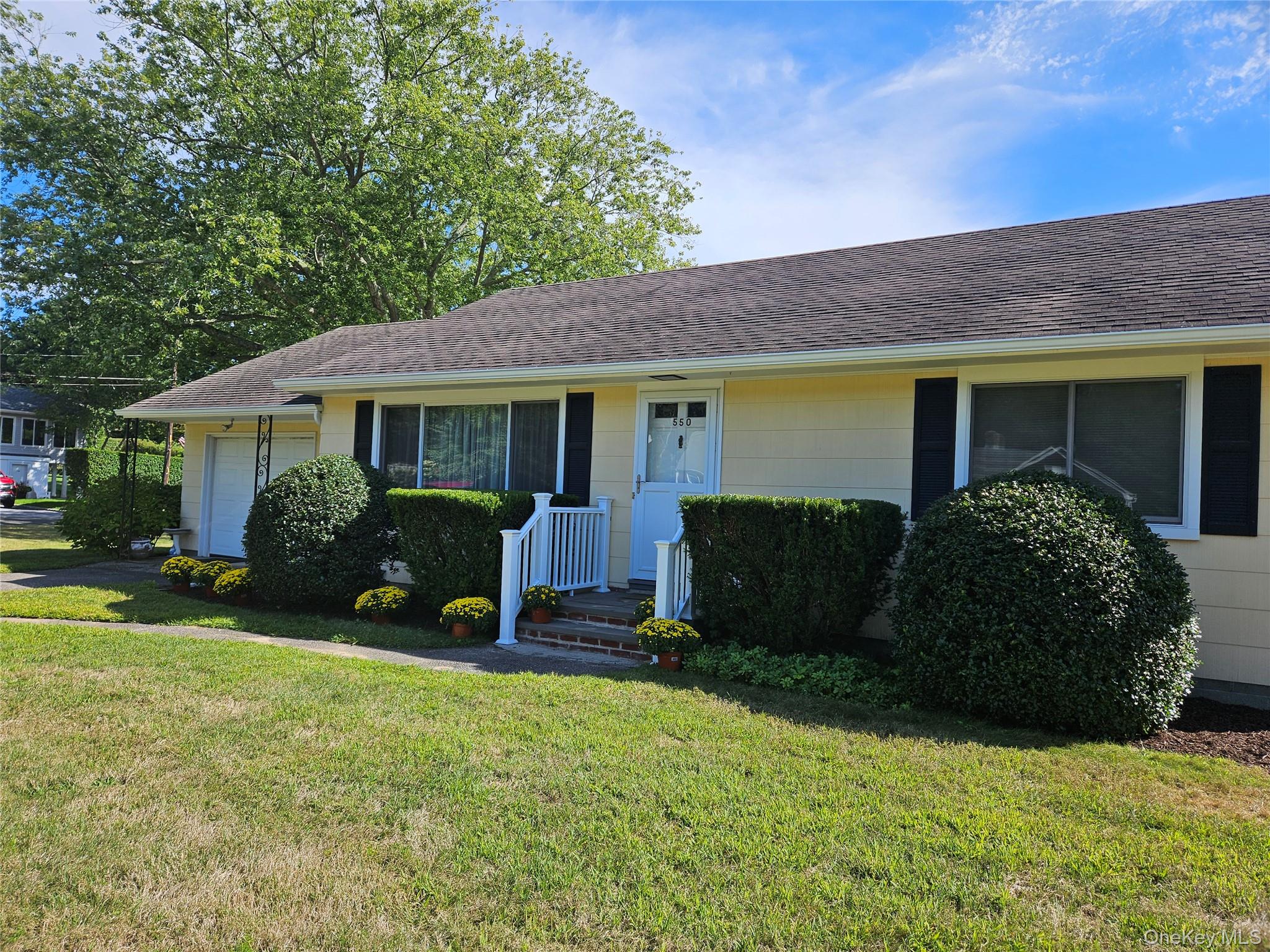 a view of a house with backyard and sitting area